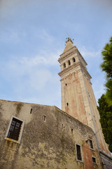 Fototapeta na wymiar Low angle shot of baroque style tower of St. Euphemia church in Rovinj Istria Croatia during noon of the sunny summer day