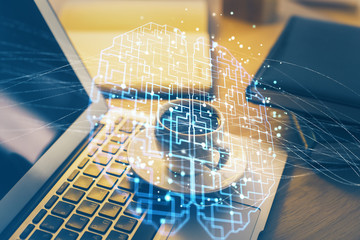 Double exposure of work space with computer and human brain drawing hologram. Brainstorm concept.