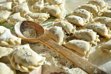 Dumplings, ravioli with cheese are on the kitchen table