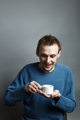 Smiling man hold cup of coffee