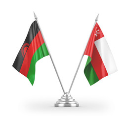 Oman and Malawi table flags isolated on white 3D rendering