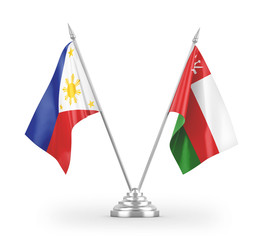 Oman and Philippines table flags isolated on white 3D rendering