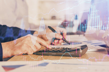 Financial trading graph multi exposure with man desktop background.