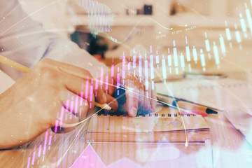Multi exposure closeup hands with stock market forex graph.