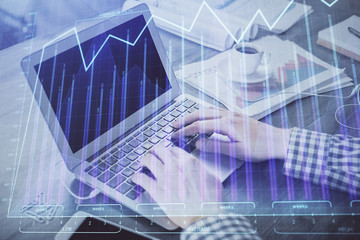 Double exposure of forex graph with man working on computer on background. Concept of market analysis.