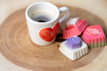 Coconut milk jelly, cup coffee on textured wooden tray.