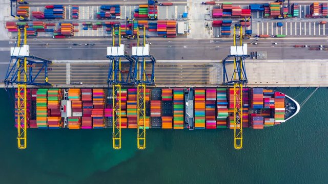 Container ship loading and unloading in deep sea port, Aerial view container shipyard business logistic import and export cargo freight ship, transportation by container ship in open sea, Timelapse 4k