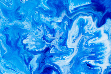 Fototapeta na wymiar Classic blue and white watercolor paint in abstract striped swirling blurry shapes for design. An interesting unusual beautiful background in macro from streaks of spread mixed paint. Blurry paint.
