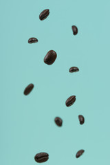 Falling coffee grains on a light background. Texture for design. Freezing in motion.