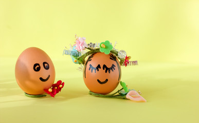 Natural easter eggs with funny painted face and sweet flower wreath. funny smiling characters for...