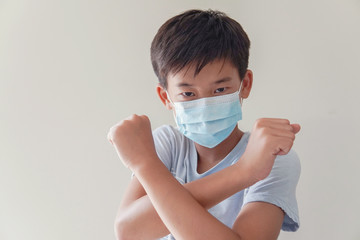 Asian preteen boy wearing medical face mask and making stop sign, coronavirus, covid-19  pandemic, pm 2.5 air pollution and health, stop Asian hate concept