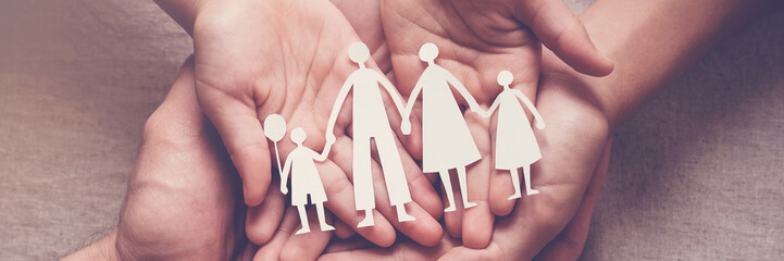 Adult and children hands holding paper family cutout, family home, adoption, foster care, homeless...