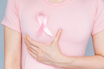 World Breast Cancer Day Concept,health care - woman wore white t-shirt,Pink ribbon for breast...