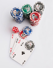 Poker chips, cards and dice on a white background. The concept of gambling and entertainment....