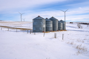 Wind turbines behind grain storage bins near Rosebud, Alberta, Canada © jkgabbert