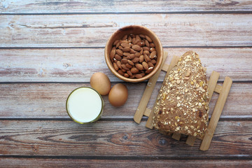 top view of almond, eggs , milk and bread on table 