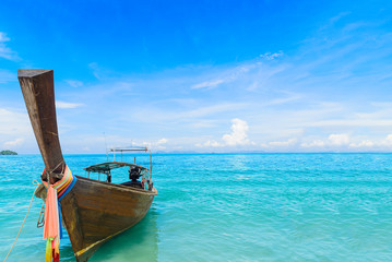 Fototapeta na wymiar Stunning sea landscape with wooden boat in te water on Ao Nang beach in Krabi, Thailand.