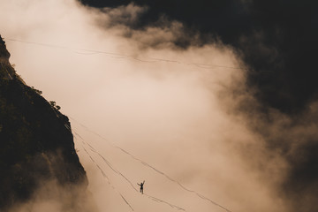 Highliner goes on a sling above the clouds.