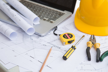 Yellow hard hat tools and drawings