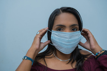 Woman puts a mask on her face. Concept virus