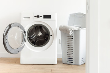 Washing machine with laundry basket in the home laundry room