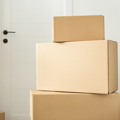 Stack cardboard boxes in living room. Space for text