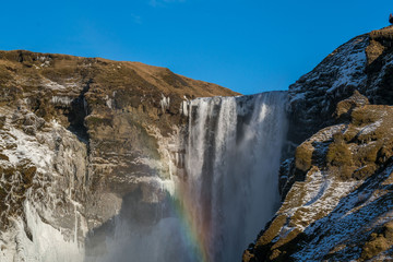 Fototapeta na wymiar Morning landscapes at Skogafoss (Skoga waterfall) with rainbow in Iceland