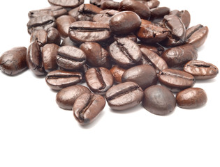 a pile of coffee beans medium roast solated on white background with copy space