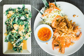 traditional Thai food-vegetables with omelet and fried shrimp with hot sauce
