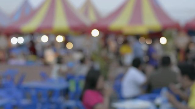 Blurred peoples in local food festival in phuket. Unrecognized peoples having some street food in the market in thailand.