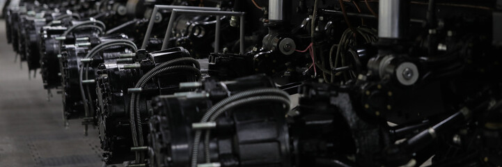 Fototapeta premium Close-up of joint washers on cross of automobile cardan shaft. Mechanical parts of auto steering system repaired in modern workroom. Car repairing workshop concept