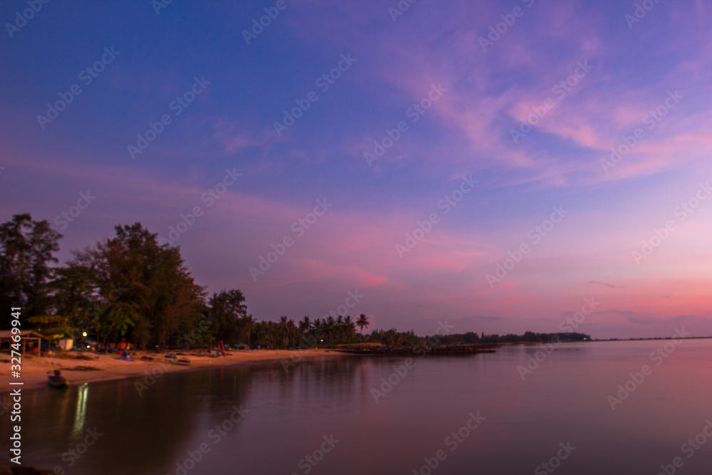 Wall mural blurry nature background of the twilight sky in the evening and the many roadside trees, the beauty 