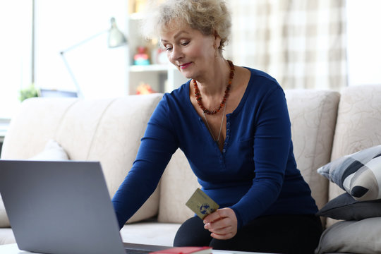 Woman Holding Credit Card While Sitting With Laptop. Opening Web Page And Following Link. Computer Literacy Training For Senior Citizens. Create Personal Online Banking Profile For Payment