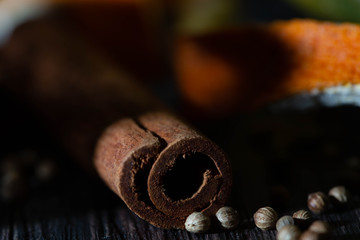 Cinnamon, orange crusts and spices set on a wooden table