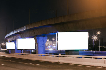 Obraz premium Billboard mockup outdoors, Outdoor advertising poster at night time with street light line for advertisement street city night.