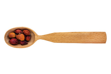 Dried Rosa berries in a wooden spoon on a white background. Phytotherapy and disease prevention....