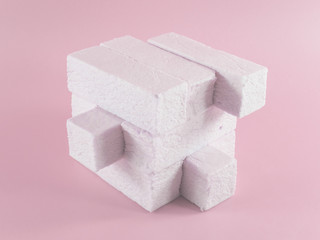 Sweet pink marshmallow rectangular shape in the form of a geometric shape. Marshmallows with the taste of cranberries, strawberries or other berries. Pop art design, creative concept