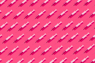 Medicinal pattern from syringes with hot pink drugs or serum.