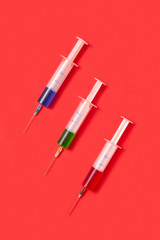 Therapeutic set of sterile plastic syrenges with colorful vaccines.