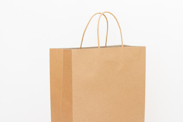 Craft brown paper shopping bag isolated on white background. Ecology concept