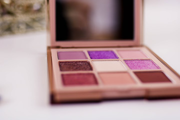 Nine colors eye shadow kit isolated on a white background.