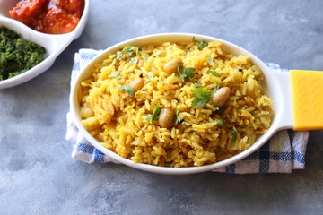 Indian comfort Food - Fresh Masala peanuts rice also known as Peanuts Pulav or rice khichdi. Garnished with coriander. Served hot with green chutney and mango pickle. with Copy space. 