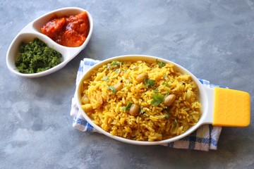 Indian comfort Food - Fresh Masala peanuts rice also known as Peanuts Pulav or rice khichdi. Garnished with coriander. Served hot with green chutney and mango pickle. with Copy space. 