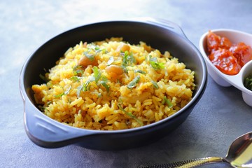 Indian comfort Food - Fresh Masala peanuts rice also known as Peanuts Pulav or rice khichdi. Garnished with coriander. Served hot with green chutney and mango pickle. with Copy space. 