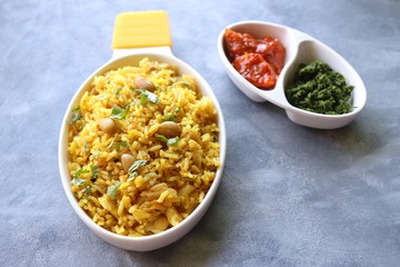 Indian comfort Food - Fresh Masala peanuts rice also known as Peanuts Pulav or rice khichdi. Garnished with coriander. Served hot with green chutney and mango pickle. with Copy space. 