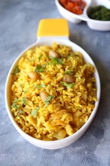 Indian comfort Food - Fresh Masala peanuts rice also known as Peanuts Pulav or rice khichdi. Garnished with coriander. Served hot with green chutney and mango pickle. with Copy space. 