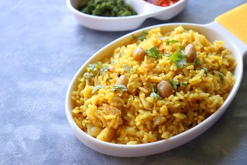 Indian comfort Food - Fresh Masala peanuts rice also known as Peanuts Pulav or rice khichdi. Garnished with coriander. Served hot with green chutney and mango pickle. with Copy space. 