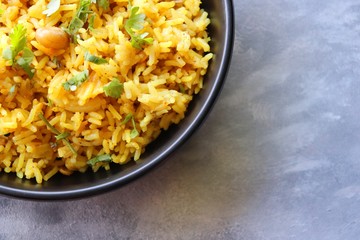 Indian comfort Food - Fresh Masala peanuts rice also known as Peanuts Pulav or rice khichdi. Garnished with coriander. Served hot with green chutney and mango pickle. with Copy space. 