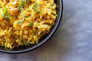 Indian comfort Food - Fresh Masala peanuts rice also known as Peanuts Pulav or rice khichdi. Garnished with coriander. Served hot with green chutney and mango pickle. with Copy space. 
