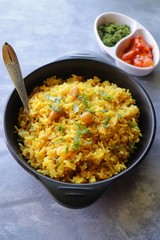 Indian comfort Food - Fresh Masala peanuts rice also known as Peanuts Pulav or rice khichdi. Garnished with coriander. Served hot with green chutney and mango pickle. with Copy space. 
